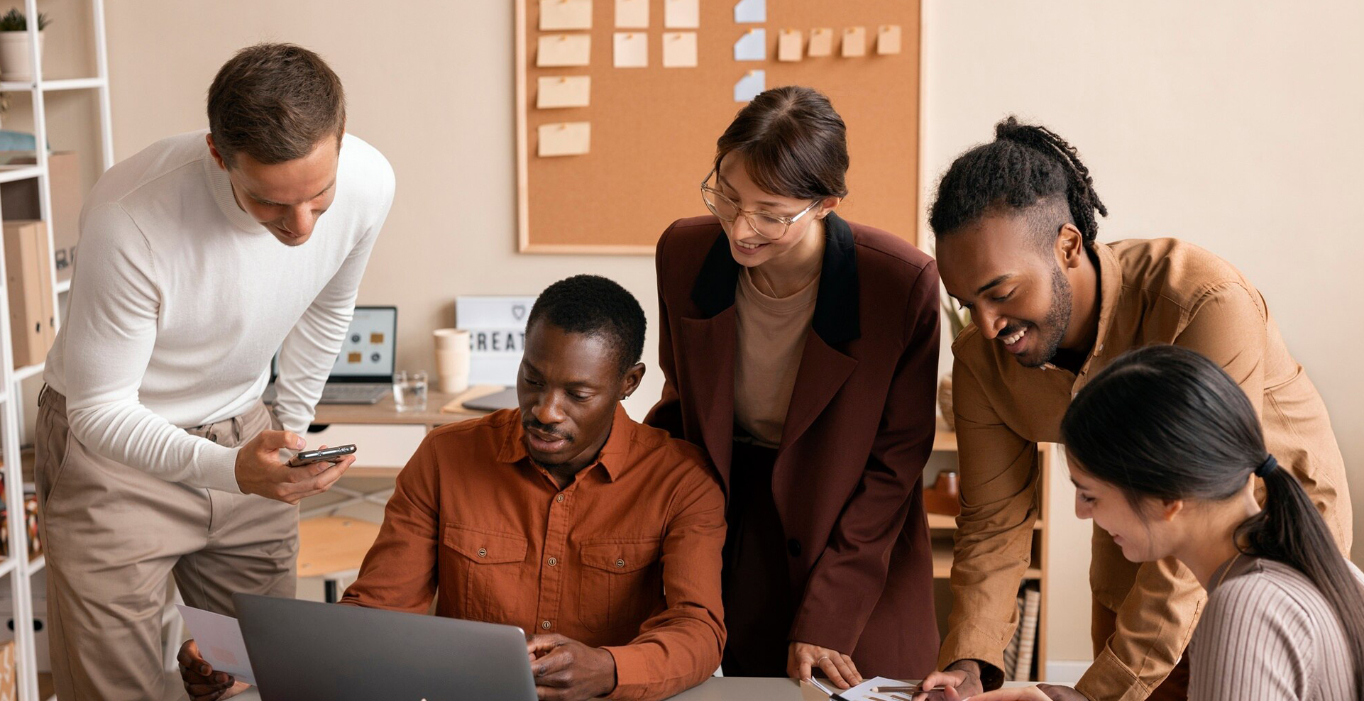 A diverse group of professionals collaborating in a modern workshop space